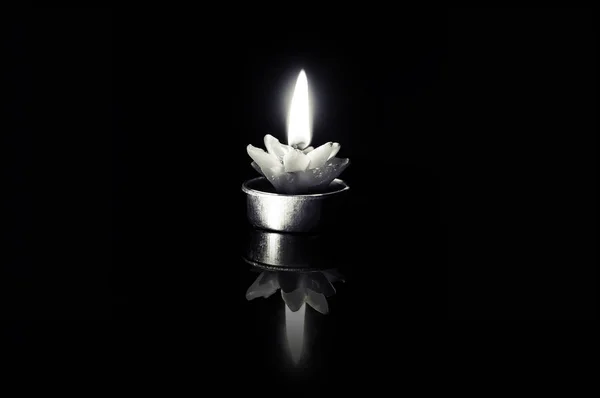 Fire black candle on a black background — Stock Photo, Image