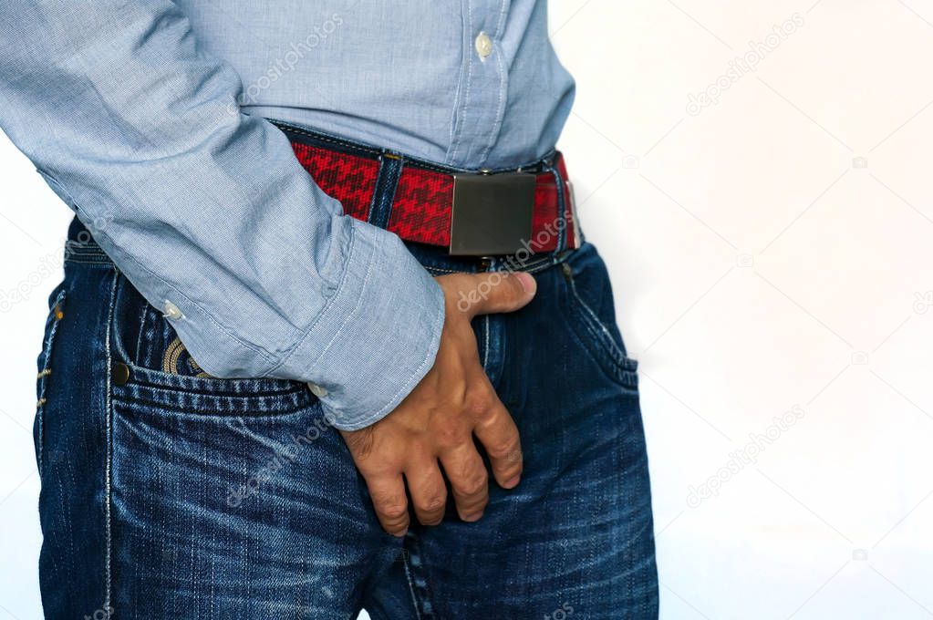 Man hand holding on middle crotch of trousers