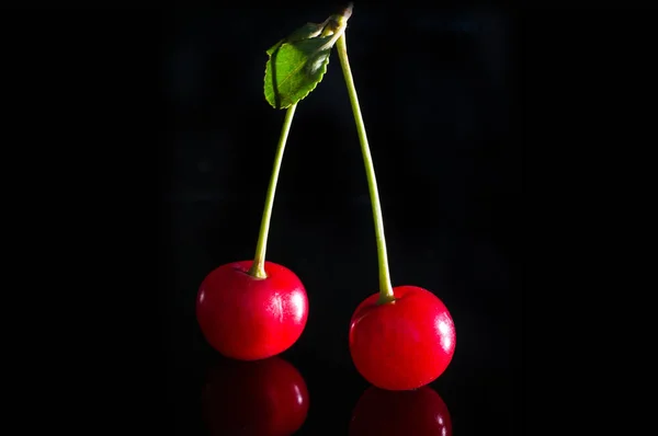 Red cherries on black