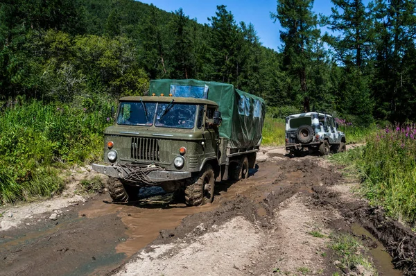 Μεγάλο φορτηγό off-road τραβά pross μικρό Suv. — Φωτογραφία Αρχείου