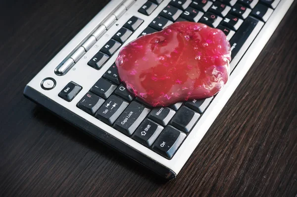 Keyboard cleaning gel is laying on the notebook.