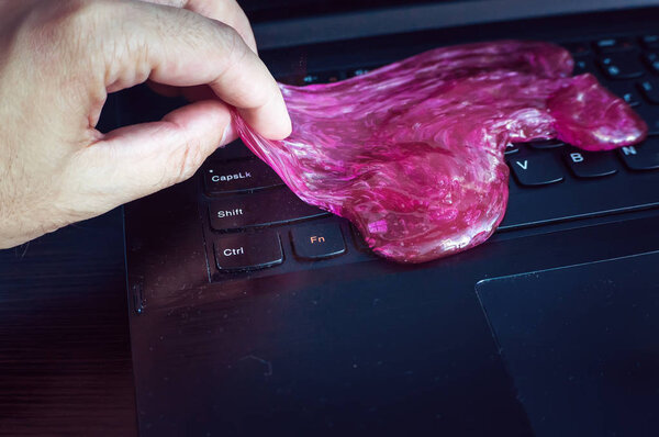 Keyboard cleaning gel is laying on the notebook.