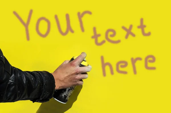 Guy in the black jacket with a graffiti spray — Stock Photo, Image