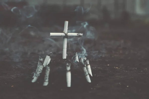 Tomb of cigarettes and cigarettes with tobacco smoke. — Stock Photo, Image