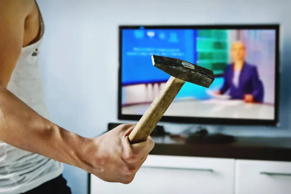 Exasperated the young man the bad news breaks the TV — Stock Photo, Image