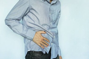 Man with stomach pain on blue background clipart