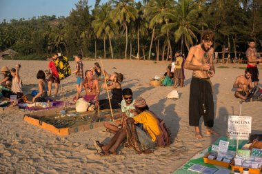 local hippies sell hand-made goods at a flea market in Gokarna clipart