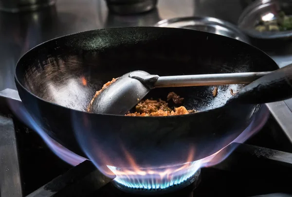 Chef frying on the gas stove with fire — Stock Photo, Image