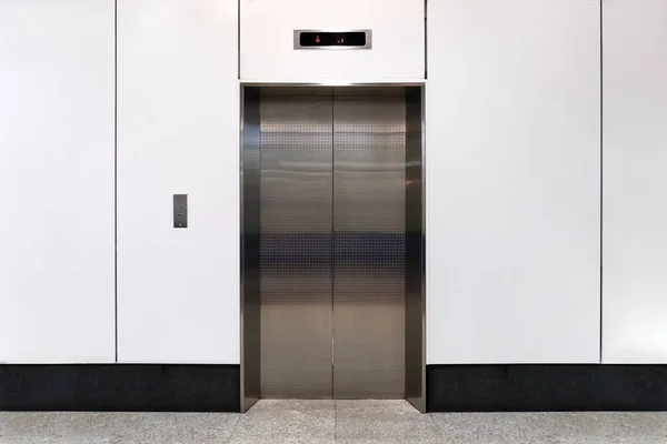 An empty modern elevator or lift with metal doors