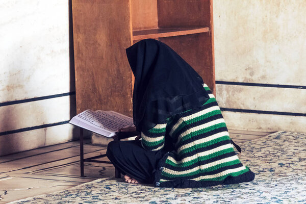A Muslim woman with a black headscarf