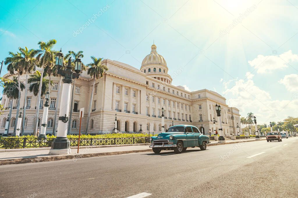 vintage American retro car rides on an asphalt road in front of the Capitol in old Havana. Tourist taxi cabriolet.