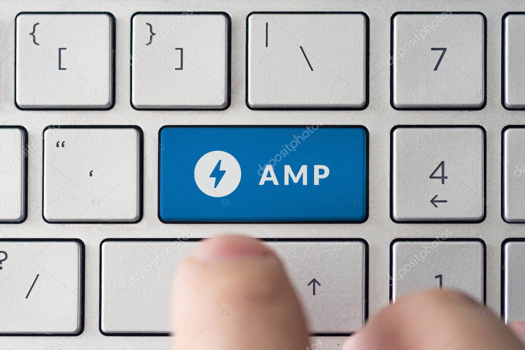 February 9, 2020, Barnaul, Russia. The male presses a button on the keyboard with the amp logo.