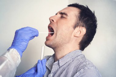 DNA test. Doctor Doing Coronavirus covid 19 Test For male Patient. Taking a saliva sample from a man. Collection of mucus from the throat for research in the laboratory. clipart
