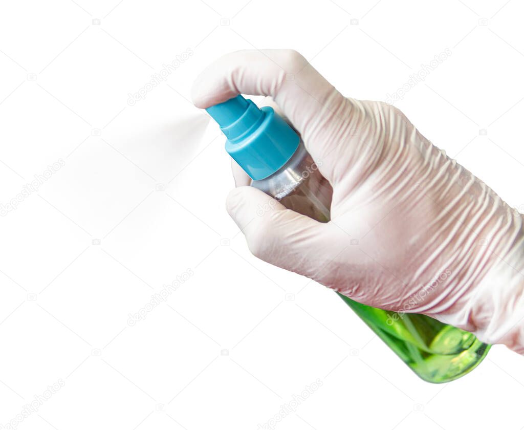 A male hand in a medical glove holds an antiseptic against coronavirus and sprays it into the air. Isolated on a gray background. concept.