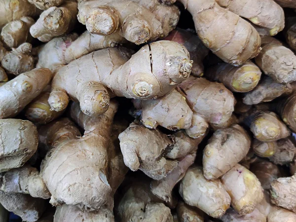heap of ginger root. Root vegetables for the prevention of colds flu and coronavirus in the store on the counter. Useful to the immune system. Shortage and rise in price of ginger. ginger background.