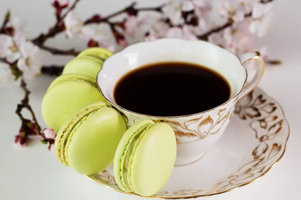Colorful macaroons  and a cup of coffee  on wooden table. — Stock Photo, Image