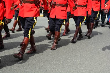 Marching red tunic RCMP officers march in honor of a fallen comrade.Boots marching in unison. clipart