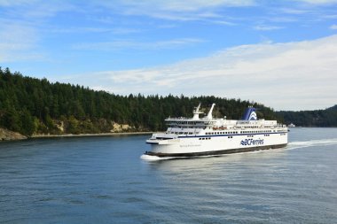 Active Pass BC, October 1st,2019.BC ferry fleet ship Spirit of British Columbia glides through the waters. clipart