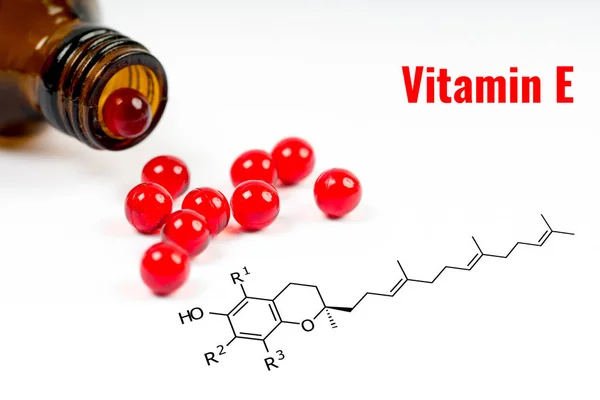 Vitamin e, capsules with chemical structure — Stock Photo, Image