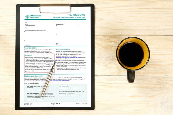 uk empty tax form sa100 in paper holder over office table