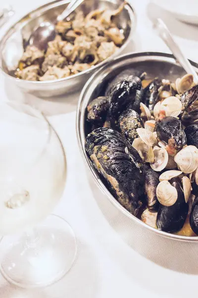 Блюдо с моллюсками и моряками Мидии со стаканом белой лозы — стоковое фото