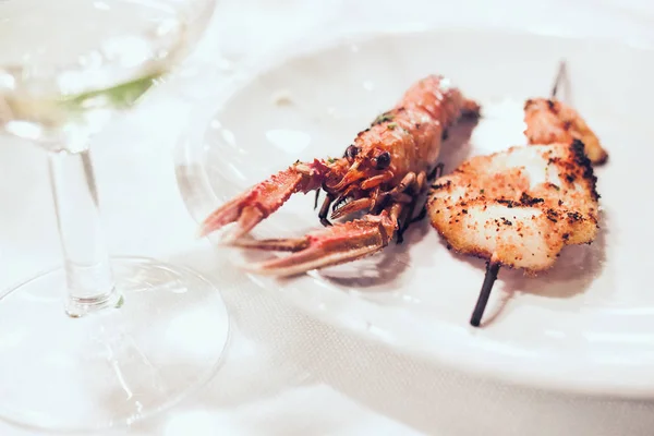 Plate with fresh grilled scampi on the restaurant table