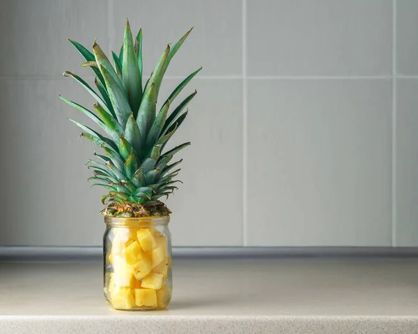 Fresh juicy pineapple pieces in a glass jar — Stock Photo, Image