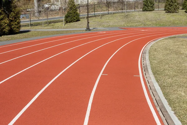 Red running track in school stadium. Sport recreation. Healthy lifestyle concept