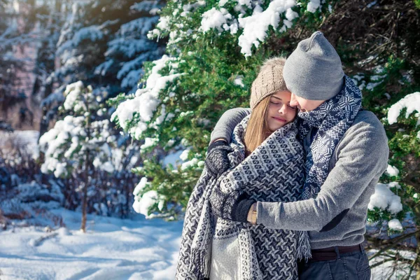Casal apaixonado coberto com abraços de cobertor na floresta de inverno — Fotografia de Stock