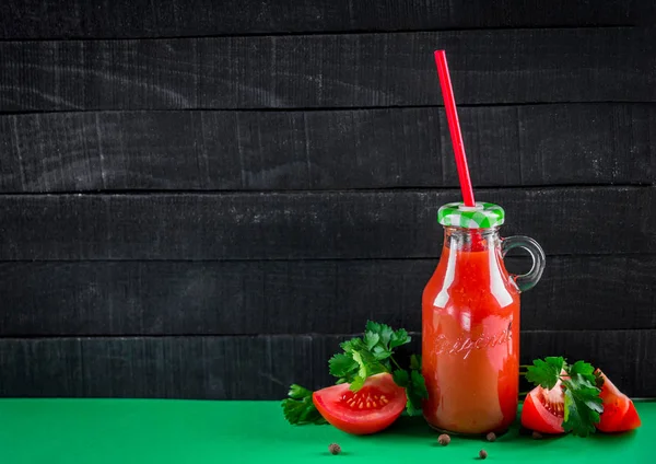 Tomato juice on black background — Stock Photo, Image