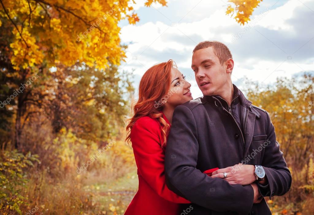 Young couple hugs in autumn forest