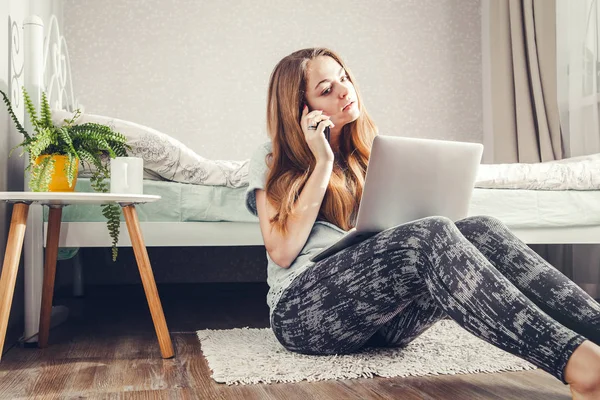 Young woman using her laptop in the bedroom — Stock Photo, Image