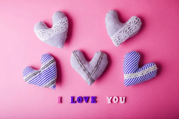 Hearts with I love you lettering on pink background. Valentine\'s day concept.