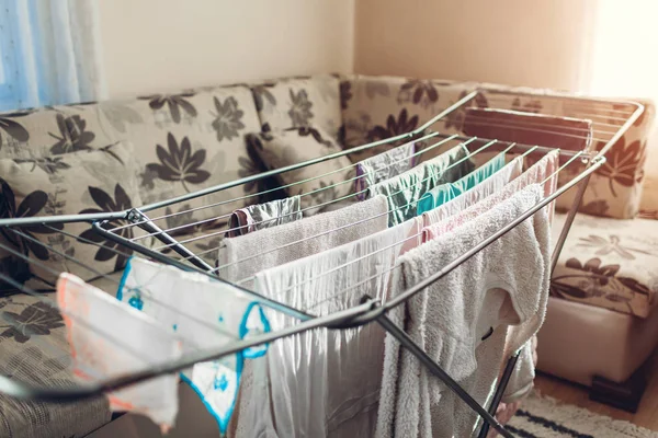 Roupas limpas penduradas no secador após a lavagem em casa. Serviços de limpeza e tarefas domésticas — Fotografia de Stock