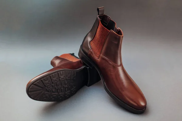 Shoes, chelsea leather boots for men. Male winter, autumn or spring fashion. Brown footwear on grey background. Sale