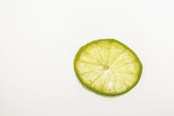 Lime slice against white background — Stock Photo, Image