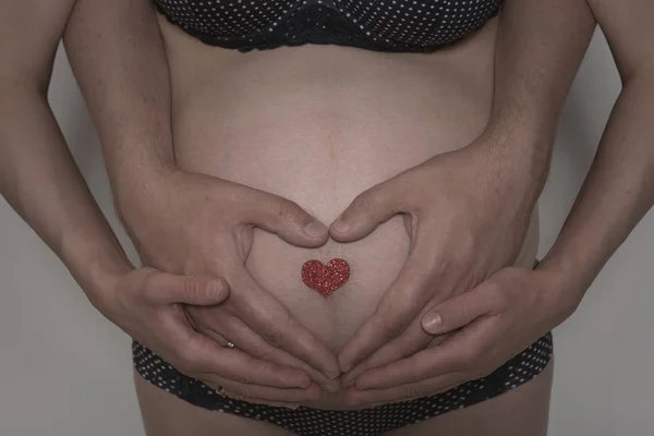 Baby belly with hands — Stock Photo, Image