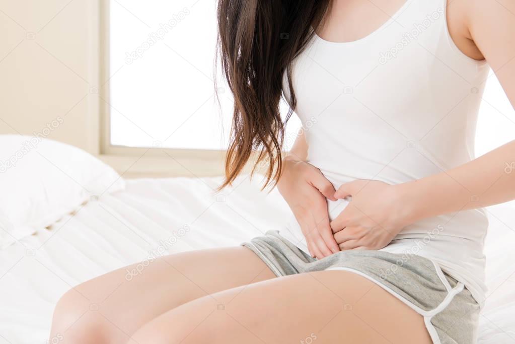 Beautiful asian woman suffering from stomach Physiological perio