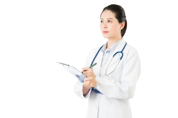 Asiatique médecin tenant stylo écriture cas médical sur presse-papiers — Photo