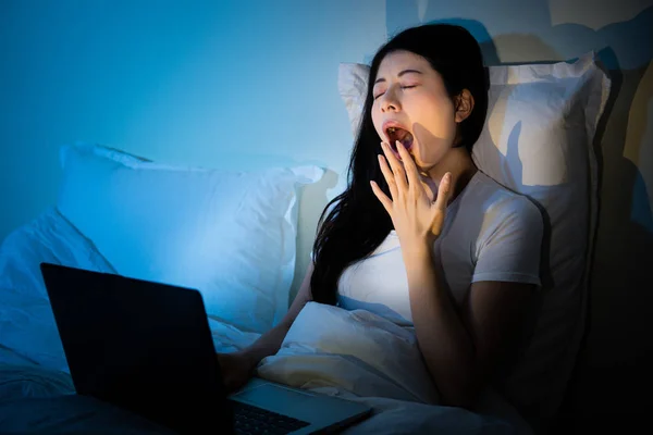 Sleepy yawn tired woman sitting on cosy bed — Stock Photo, Image