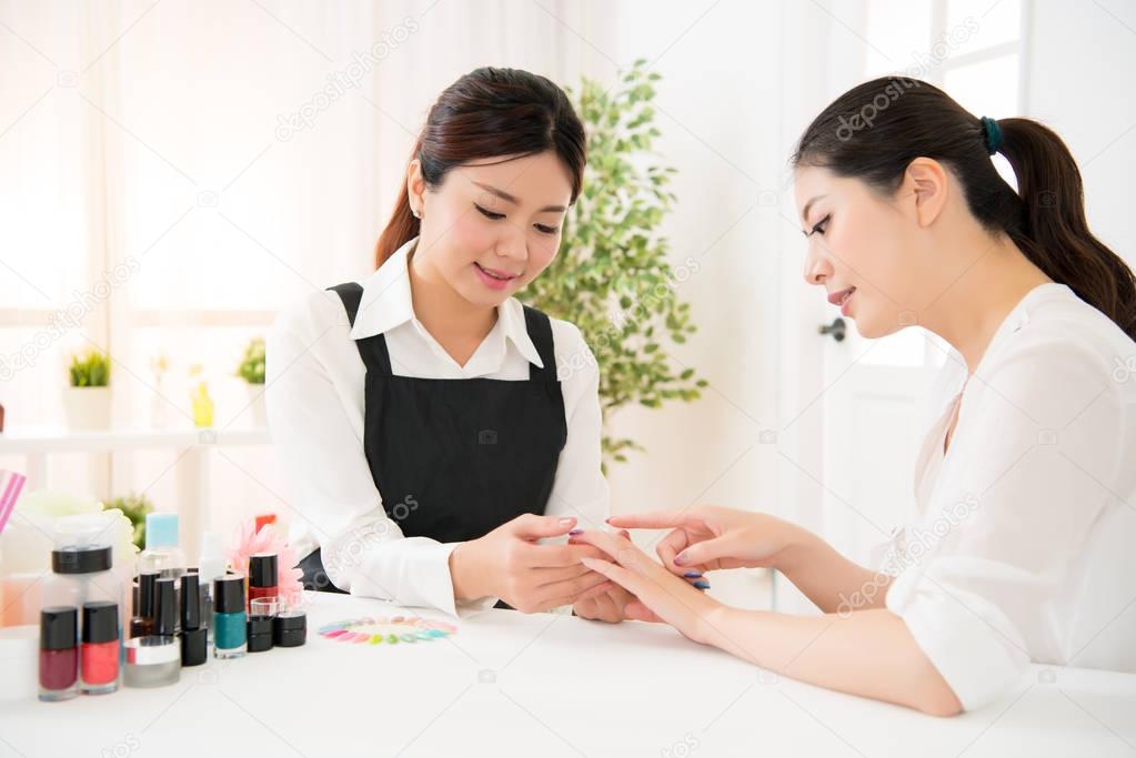 manicurist and her client are discussion