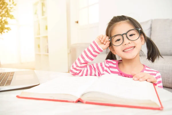 Leende flicka hålla glasögon läsa en böcker — Stockfoto