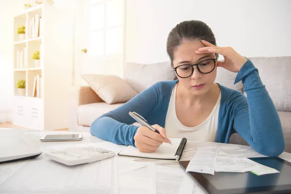 Woman looking distressed over bills — Stock Photo, Image