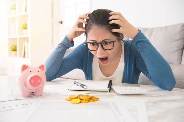 Woman crazy to see money from piggy bank — Stock Photo, Image