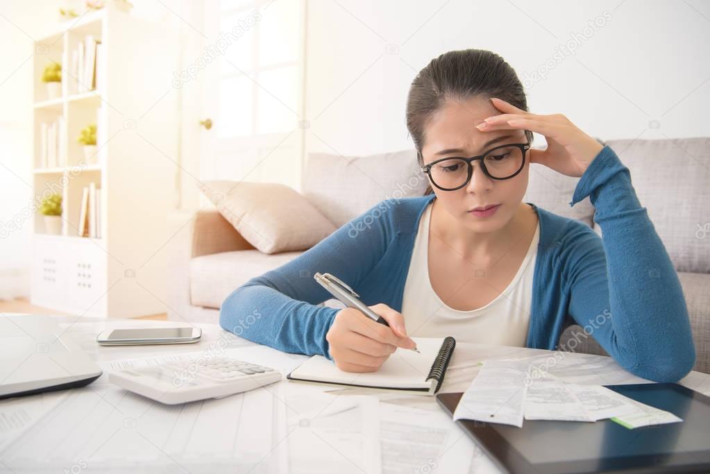 woman looking distressed over bills