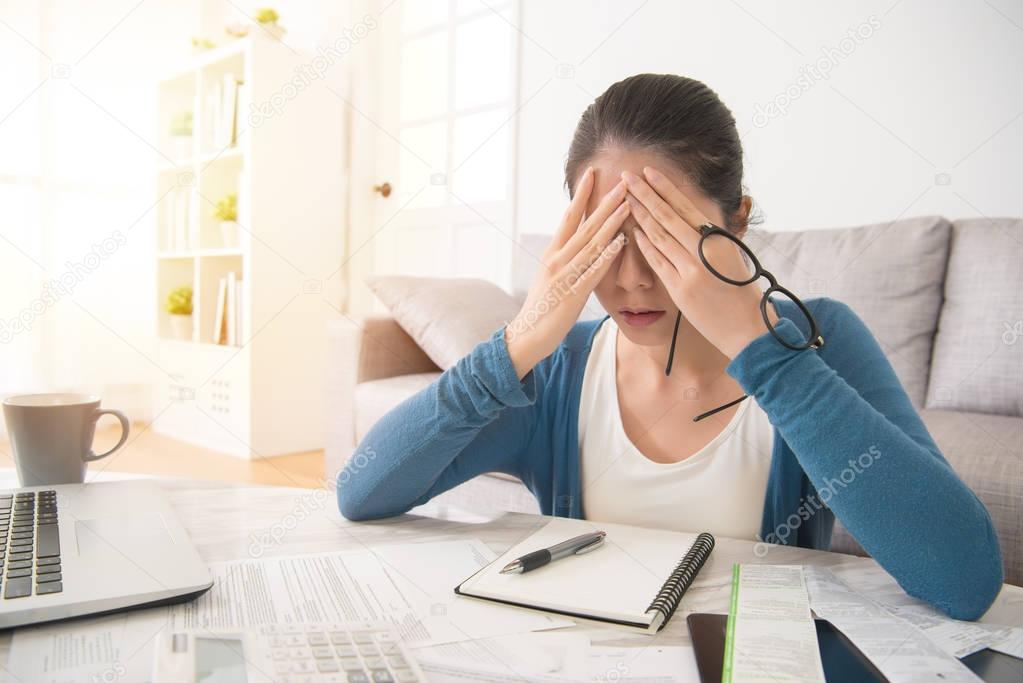 depressed woman after checking bills 