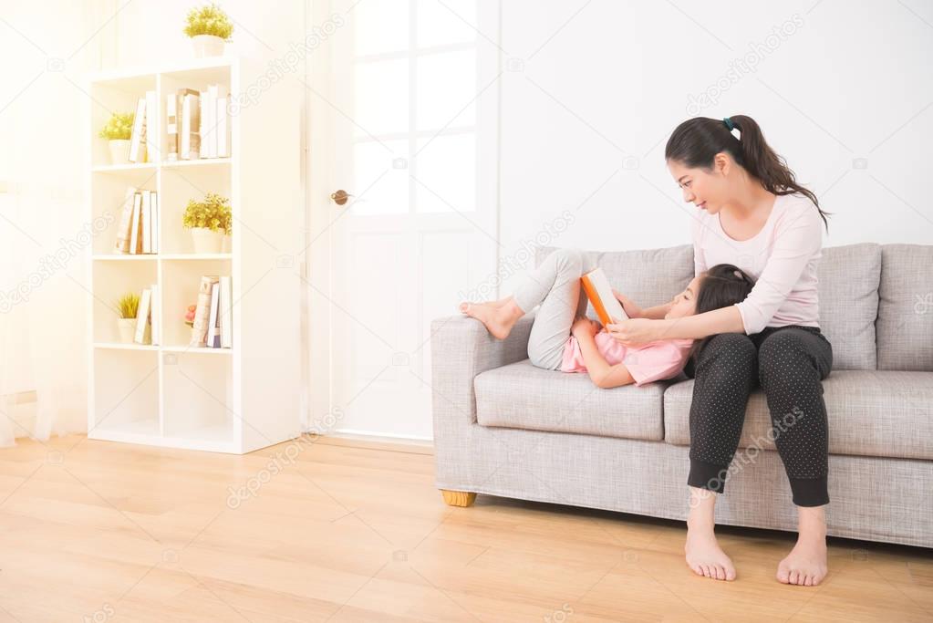 mother sitting on the couch with daughter