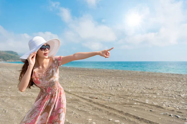 Turista fêmea pegar agarrando seu chapéu soprando vento — Fotografia de Stock