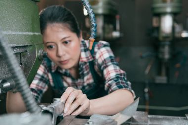 çalışan çelik parçaları otomatik makineye koy.