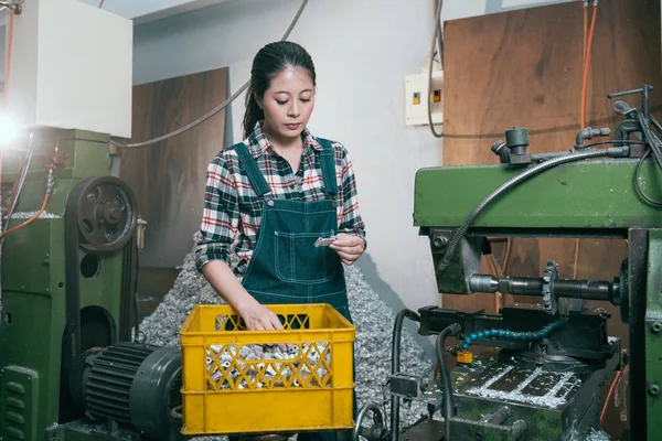 Lathe factory female manager looking at product — Stock Photo, Image